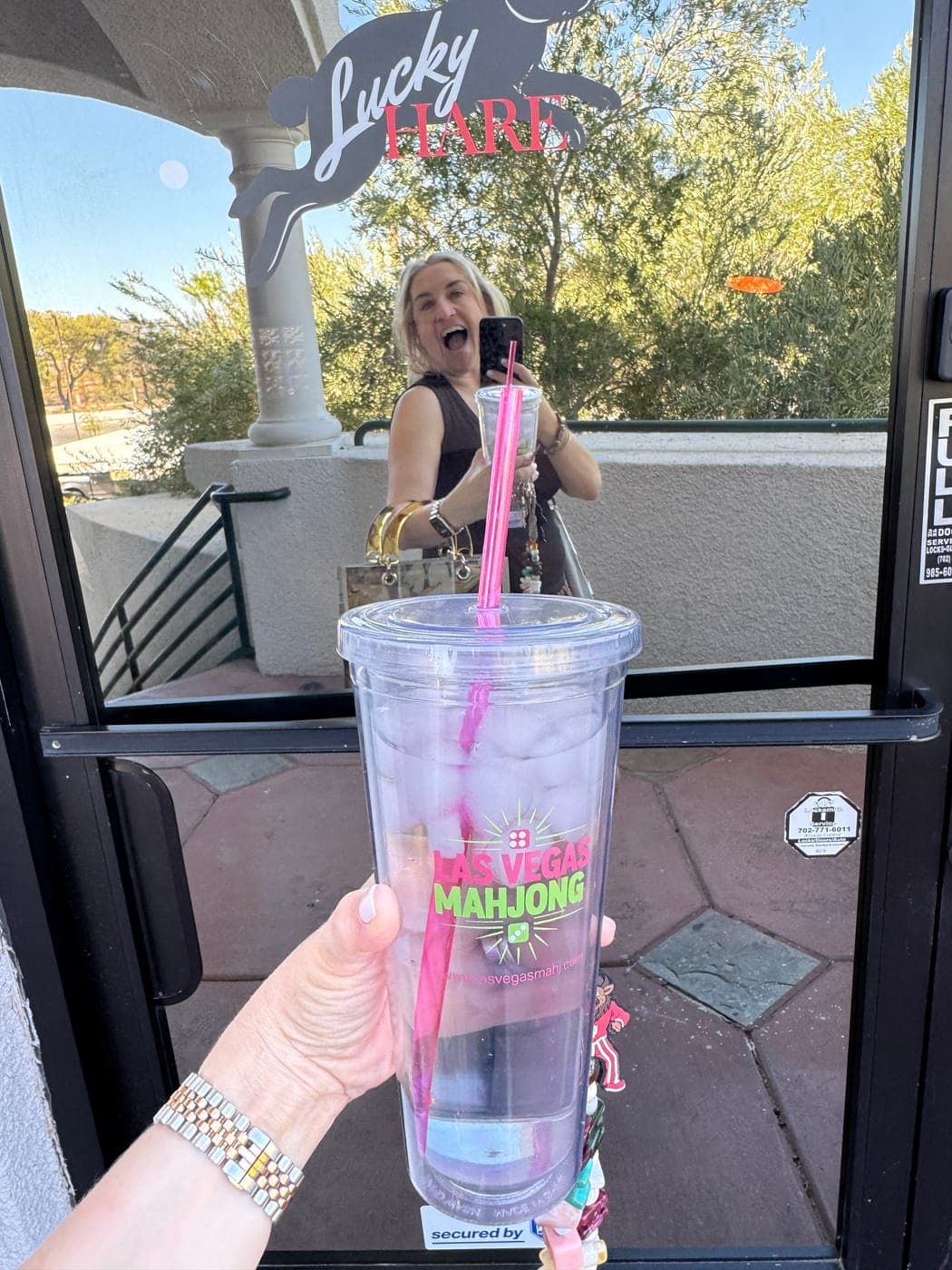 A Las Vegas Mahjong tumbler held up at the door of Lucky Hare on West Sahara Avenue